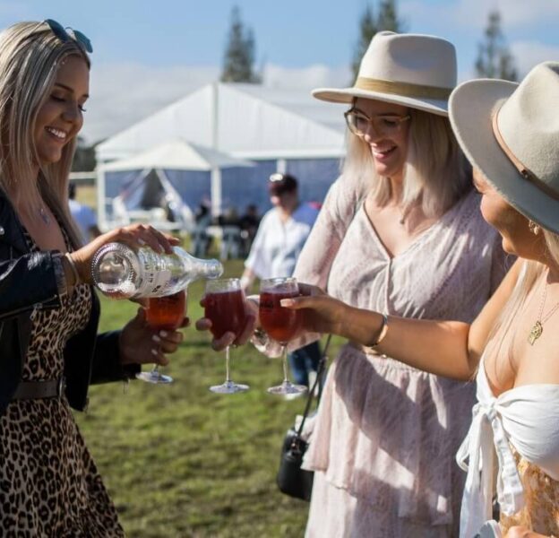 3 women with full wine glasses at the Lovedale Long Lunch