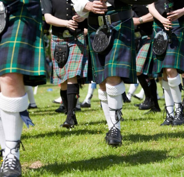 Bagpipe players wearing kilts during the Highland Games